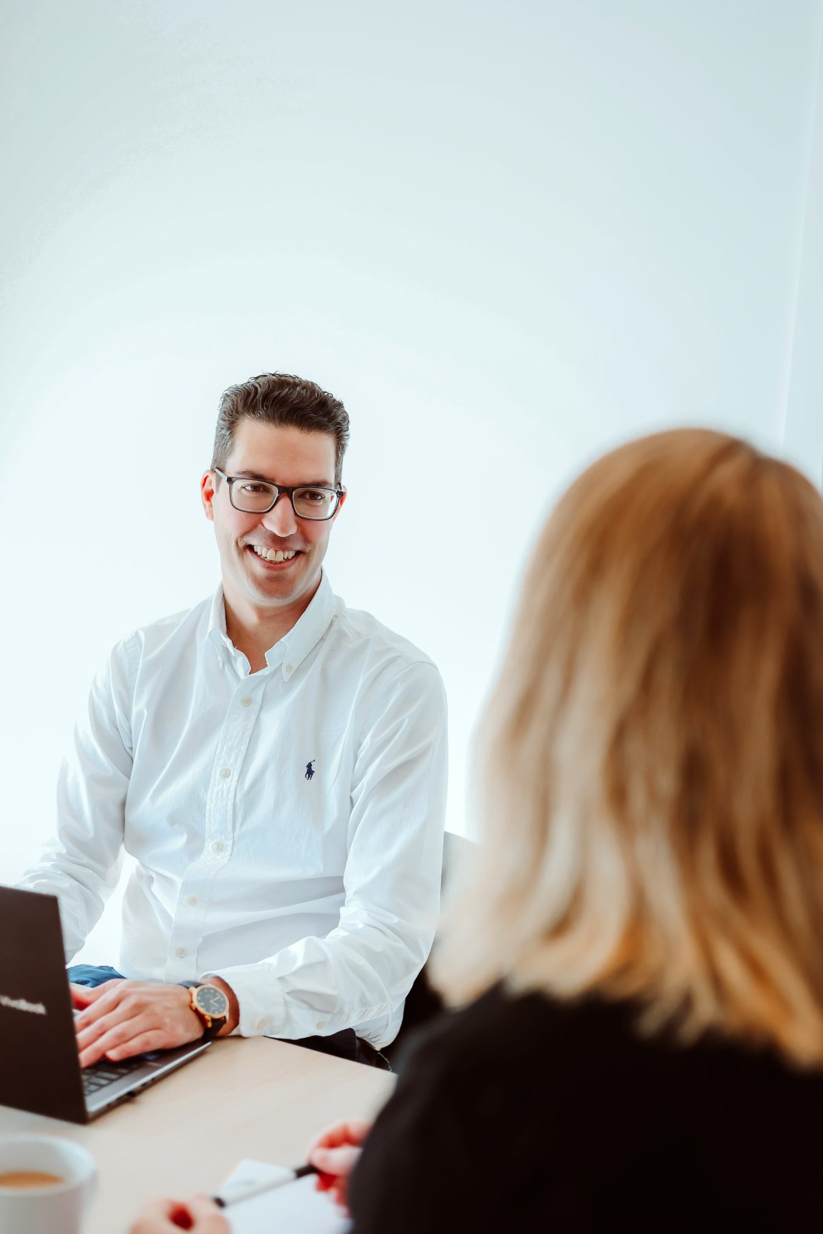 Ross Sergi, Director of Ancora Finance, talking through a loan with a client at his desk